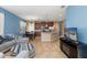 Bright living room showcases an open layout with comfortable seating, tile floors, and easy access to kitchen at 8323 Enclave Way # 104, Sarasota, FL 34243