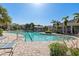 Community pool featuring lap lanes, wading area, poolside lounge chairs, and shade structures, perfect for relaxation at 8323 Enclave Way # 104, Sarasota, FL 34243