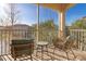 Relaxing screened porch with comfortable seating and picturesque views of lush landscape and serene lake at 8323 Enclave Way # 104, Sarasota, FL 34243