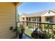 Balcony view overlooking the community courtyard; complete with black metal railing and potted plants at 8714 Mallard Reserve Dr # 201, Tampa, FL 33614