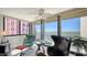 Bright living room with floor to ceiling windows and bay views, stylish furnishings and decor, tile floors at 97 Sunset Dr # 203, Sarasota, FL 34236