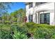 Home exterior with manicured landscaping and pond in the background at 6156 41St E St, Bradenton, FL 34203