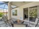 Covered patio featuring a fire pit and comfortable seating for outdoor relaxation at 6156 41St E St, Bradenton, FL 34203