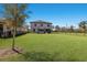 Spacious backyard with lush green lawn, framed by a sleek black fence, perfect for outdoor activities at 10905 Copperlefe Dr, Bradenton, FL 34212