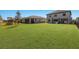 Expansive backyard featuring lush greenery, play set, and serene surroundings at 10905 Copperlefe Dr, Bradenton, FL 34212
