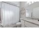 Clean bathroom featuring a shower with curtain and a granite vanity at 10905 Copperlefe Dr, Bradenton, FL 34212