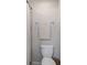 Neutral toned bathroom with a white toilet, tile accent, shower curtain and a chrome towel rack at 10905 Copperlefe Dr, Bradenton, FL 34212
