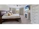 Well lit bedroom with a large bed, fireplace and a beach view on the TV in a comfortable space at 10905 Copperlefe Dr, Bradenton, FL 34212
