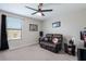This bedroom boasts a leather recliner, ceiling fan, and sports decor for the ultimate relaxation spot at 10905 Copperlefe Dr, Bradenton, FL 34212