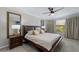 Bright bedroom with a large bed, lamps and mirrors, in a relaxing space at 10905 Copperlefe Dr, Bradenton, FL 34212