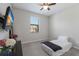 Cozy bedroom featuring a window, ceiling fan, and mounted television for comfortable living at 10905 Copperlefe Dr, Bradenton, FL 34212