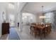 Open dining room with a chandelier, a large window, and tiled floors at 10905 Copperlefe Dr, Bradenton, FL 34212