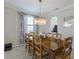 Dining room featuring a chandelier, a large wooden table, and decorative drapes at 10905 Copperlefe Dr, Bradenton, FL 34212