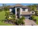 Beautiful two-story home featuring a well-manicured lawn and tropical landscaping in a sunny neighborhood at 10905 Copperlefe Dr, Bradenton, FL 34212