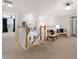 Spacious hallway featuring a staircase and decorative chairs at 10905 Copperlefe Dr, Bradenton, FL 34212
