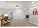 Well-lit hallway with art and chairs leading to other areas of the home at 10905 Copperlefe Dr, Bradenton, FL 34212