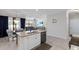 Open-concept kitchen featuring an island and stainless steel dishwasher perfect for modern living at 10905 Copperlefe Dr, Bradenton, FL 34212