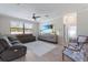 Comfortable living room with plush seating, a ceiling fan, and a mounted TV at 10905 Copperlefe Dr, Bradenton, FL 34212