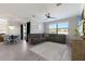 Open living area featuring a large sectional couch, TV, and access to dining area at 10905 Copperlefe Dr, Bradenton, FL 34212