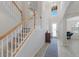 Open staircase with carpet steps, white wood railings, and natural light at 10905 Copperlefe Dr, Bradenton, FL 34212
