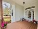 Inviting front porch featuring a beautiful blue door, wood flooring, and decorative floral arrangements at 1160 Mill Creek Rd, Bradenton, FL 34212