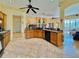 Open kitchen features wooden cabinetry, tile floors, black appliances, and views into the living room at 1160 Mill Creek Rd, Bradenton, FL 34212