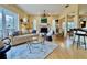 Bright living room with a fireplace, a ceiling fan, comfortable seating, and a glass coffee table with a neutral area rug at 1160 Mill Creek Rd, Bradenton, FL 34212