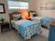 Guest bedroom with two twin beds, coastal decor, and bright natural light at 1257 S Portofino Dr # 208, Sarasota, FL 34242