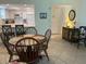 Open dining area and kitchen with neutral tile flooring and seating for six at 1257 S Portofino Dr # 208, Sarasota, FL 34242