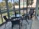 Relaxing lanai with seating, a table, and views of the tropical landscaping and waterways at 1257 S Portofino Dr # 208, Sarasota, FL 34242
