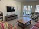 Comfortable living room with a view of the lanai and lots of natural light at 1257 S Portofino Dr # 208, Sarasota, FL 34242