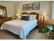 Bright main bedroom features calming decor, night stands, and large windows at 1257 S Portofino Dr # 208, Sarasota, FL 34242