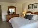 Bright main bedroom features large dresser, calming decor, and ceiling fan at 1257 S Portofino Dr # 208, Sarasota, FL 34242
