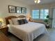 Bright main bedroom features large windows, ceiling fan, and calming decor at 1257 S Portofino Dr # 208, Sarasota, FL 34242