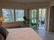Main bedroom with sliding glass doors leading to screened in patio with view at 1257 S Portofino Dr # 208, Sarasota, FL 34242