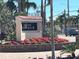 Community signage for Siesta Harbor with colorful flowers and palm trees in the background at 1257 S Portofino Dr # 208, Sarasota, FL 34242