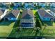 Aerial view showcasing a screened-in lanai overlooking a serene lake surrounded by lush landscaping at 13228 Saw Palm Creek Trl, Lakewood Ranch, FL 34211