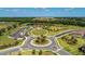Aerial shot of community park, showcasing the green space, playground, and scenic landscaping at 13228 Saw Palm Creek Trl, Lakewood Ranch, FL 34211