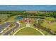 Beautiful aerial view of community amenities, including a pool, clubhouse, and lush green spaces at 13228 Saw Palm Creek Trl, Lakewood Ranch, FL 34211