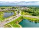 Community aerial view showcases lush landscaping, serene ponds, manicured lawns, and charming homes in a picturesque setting at 13228 Saw Palm Creek Trl, Lakewood Ranch, FL 34211
