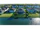 Aerial of several homes with screened-in patios looking out to a scenic lake with lush, mature landscaping at 13228 Saw Palm Creek Trl, Lakewood Ranch, FL 34211