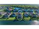 Aerial view of backyard with screened patio and lake in background. Edited to highlight the property at 13228 Saw Palm Creek Trl, Lakewood Ranch, FL 34211
