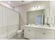 Bright bathroom features a double sink vanity, decorative lighting, and tiled floors at 13228 Saw Palm Creek Trl, Lakewood Ranch, FL 34211