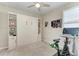 Multi-purpose bedroom with wall bed, shelving, a ceiling fan, and a Peloton exercise bike at 13228 Saw Palm Creek Trl, Lakewood Ranch, FL 34211