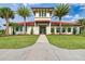 Stunning clubhouse featuring lush landscaping, tile roof, and elegant entrance, offering a welcoming community space at 13228 Saw Palm Creek Trl, Lakewood Ranch, FL 34211
