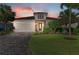 Charming single-story home with stone accents, well-manicured lawn and garden, and a two-car garage at 13228 Saw Palm Creek Trl, Lakewood Ranch, FL 34211