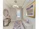 Bright foyer with modern chandelier, decorative mirror, tray ceiling, and elegant console table at 13228 Saw Palm Creek Trl, Lakewood Ranch, FL 34211