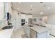 Open concept kitchen with a large island, stainless appliances and view into the living room at 13228 Saw Palm Creek Trl, Lakewood Ranch, FL 34211