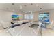 Open-concept kitchen with island seating that flows into the living room and dining area at 13228 Saw Palm Creek Trl, Lakewood Ranch, FL 34211