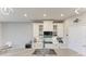 Close-up of the modern kitchen island with stainless steel sink and white cabinets at 13228 Saw Palm Creek Trl, Lakewood Ranch, FL 34211